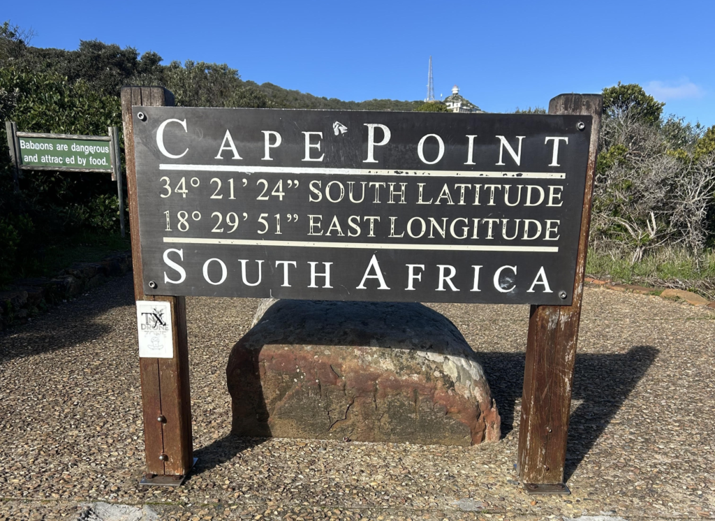 Sign detailing the latitude and longitude of Cape Point in South Africa