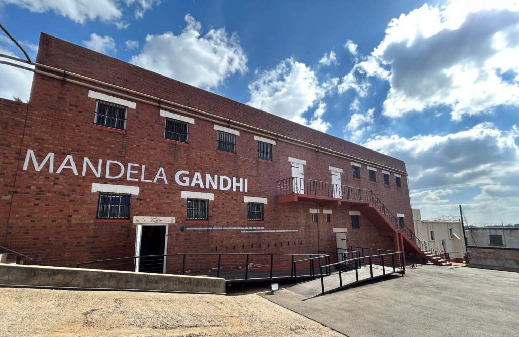 Exterior of a building at Constitution Hill with the words "Mandela Gandhi"