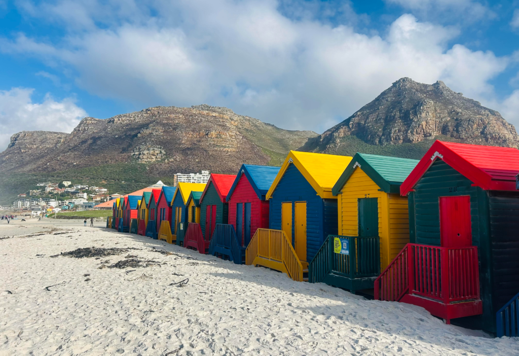 Colourful beach huts at Muizenberg beach during Cape Peninsula day trip