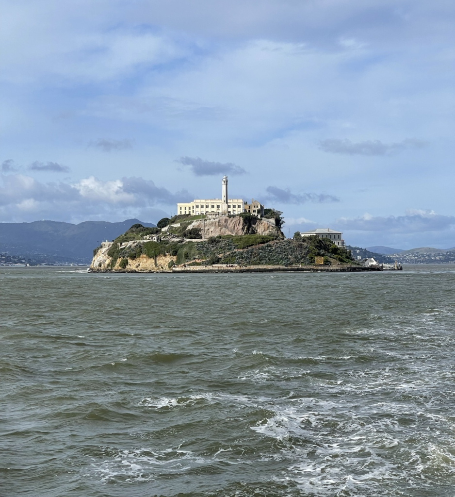 View of Alcatraz Island from the ferry on a cloudy day in San Francisco.