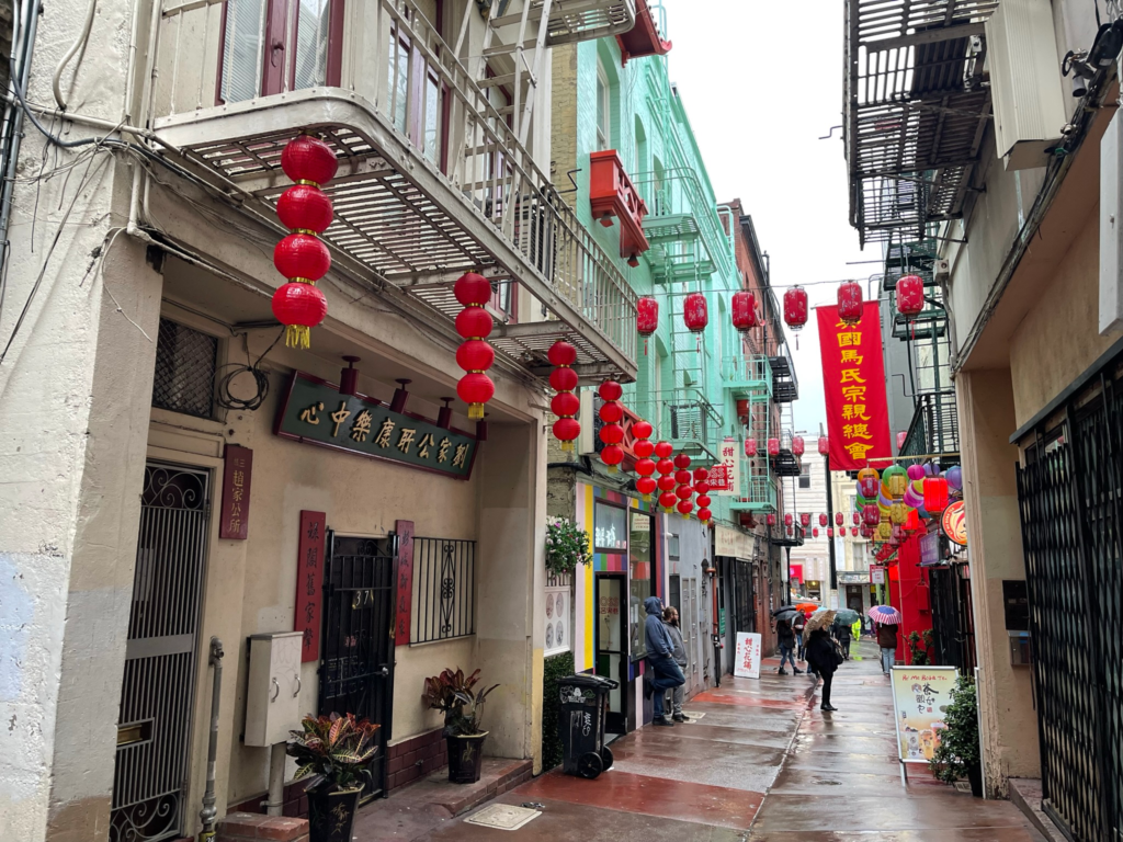 A street with lanterns in San Francisco's Chinatown on a cloudy day in January.