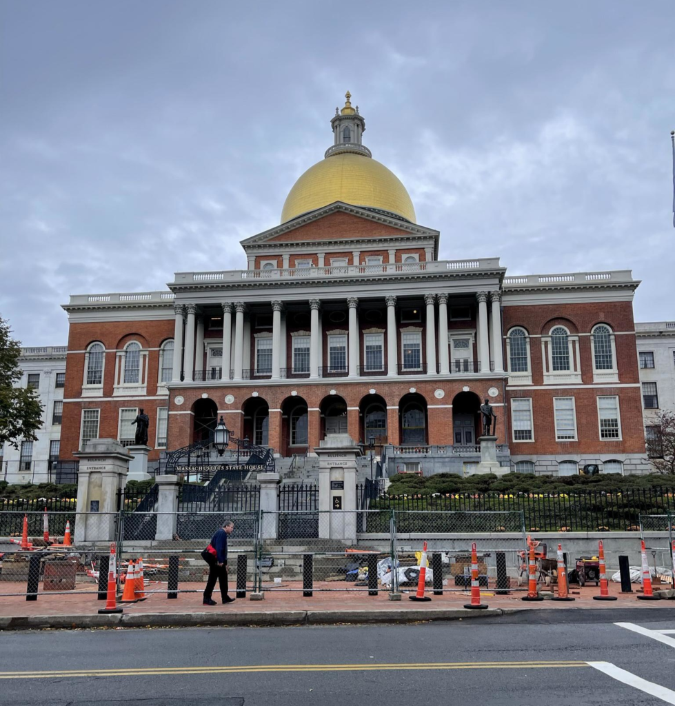 The Massachusetts State House with recognisable golden dome during construction works.